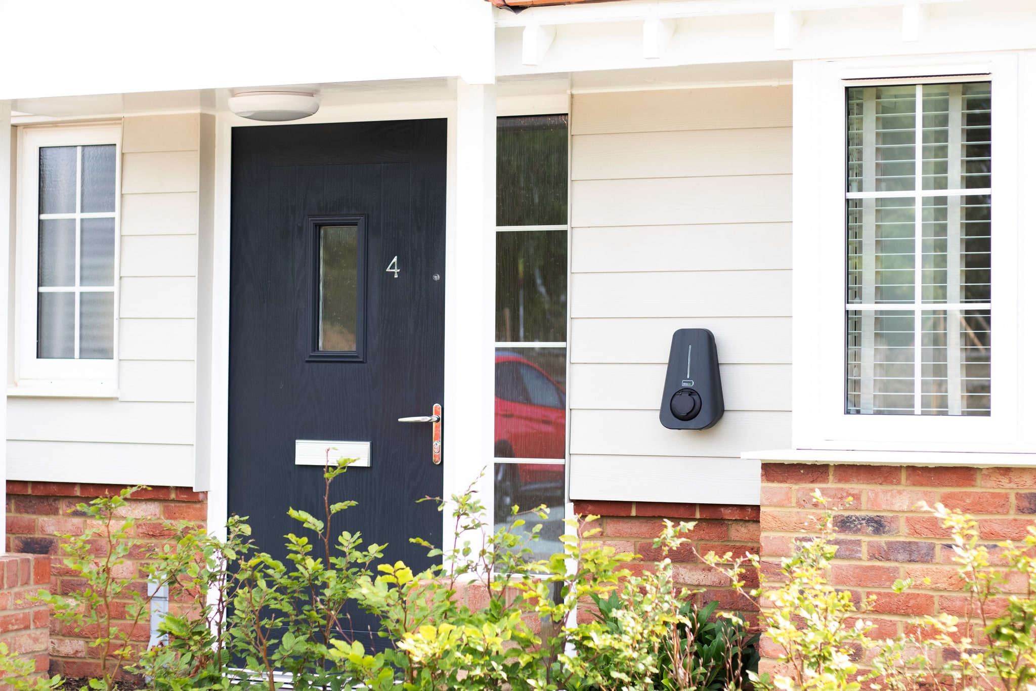 A distant photo of a wall mounted Brim Smart EV Charger