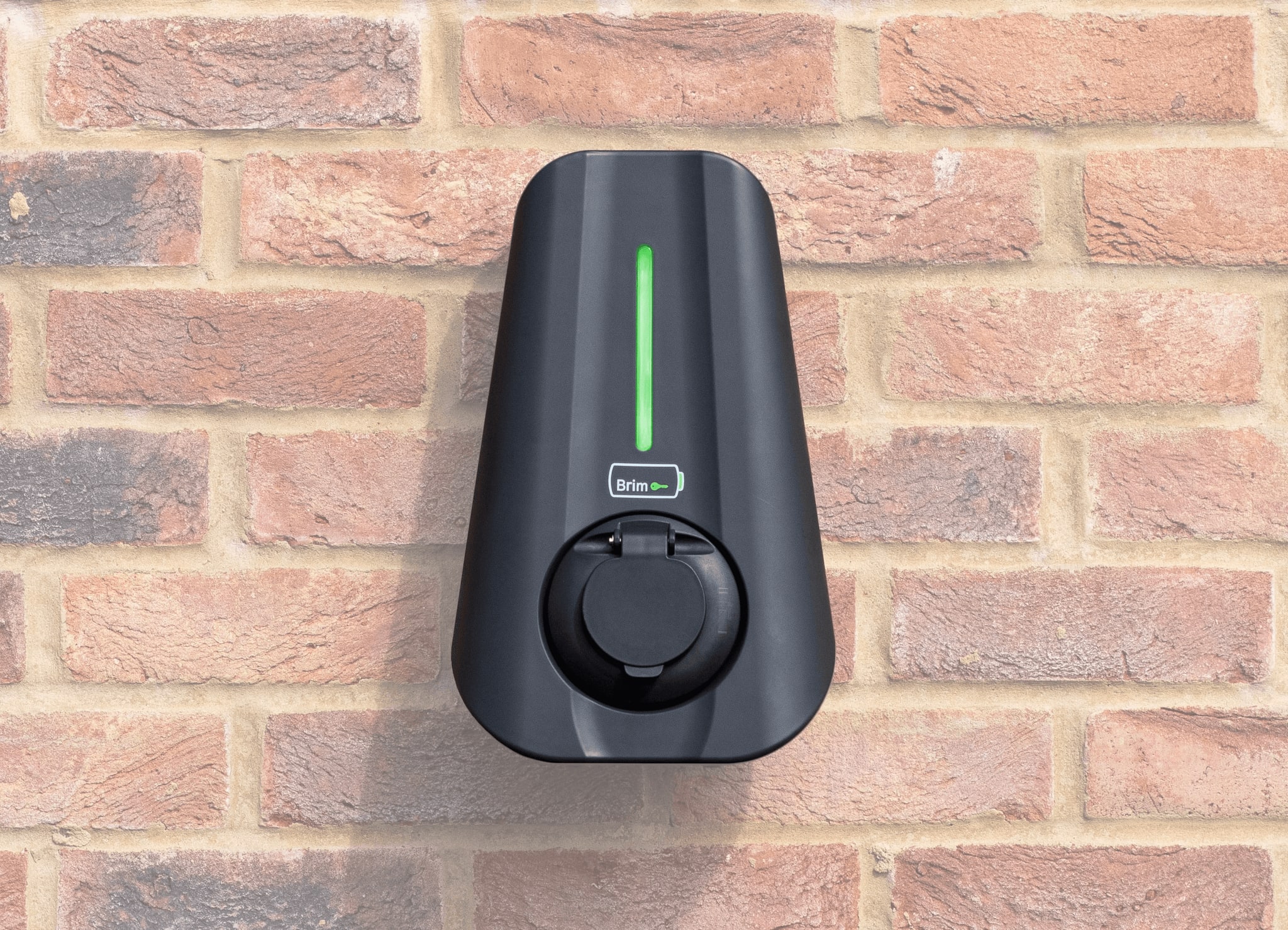 A semi-isolated close up product focused image showing the Brim charger installed on a brick wall.